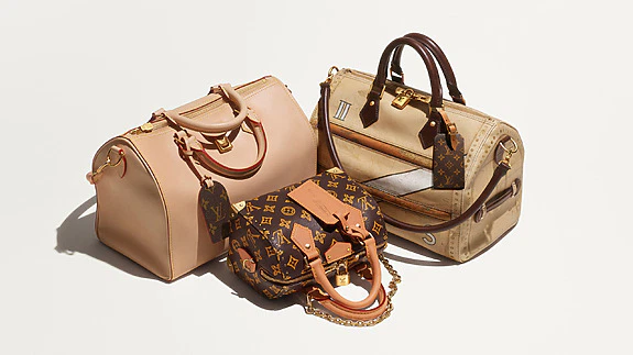 Three stylish designer handbags displayed.